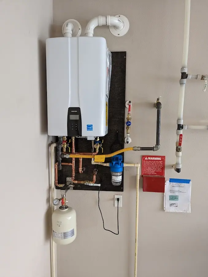 Professional plumber installing copper piping in a Eldorado at Santa Fe home